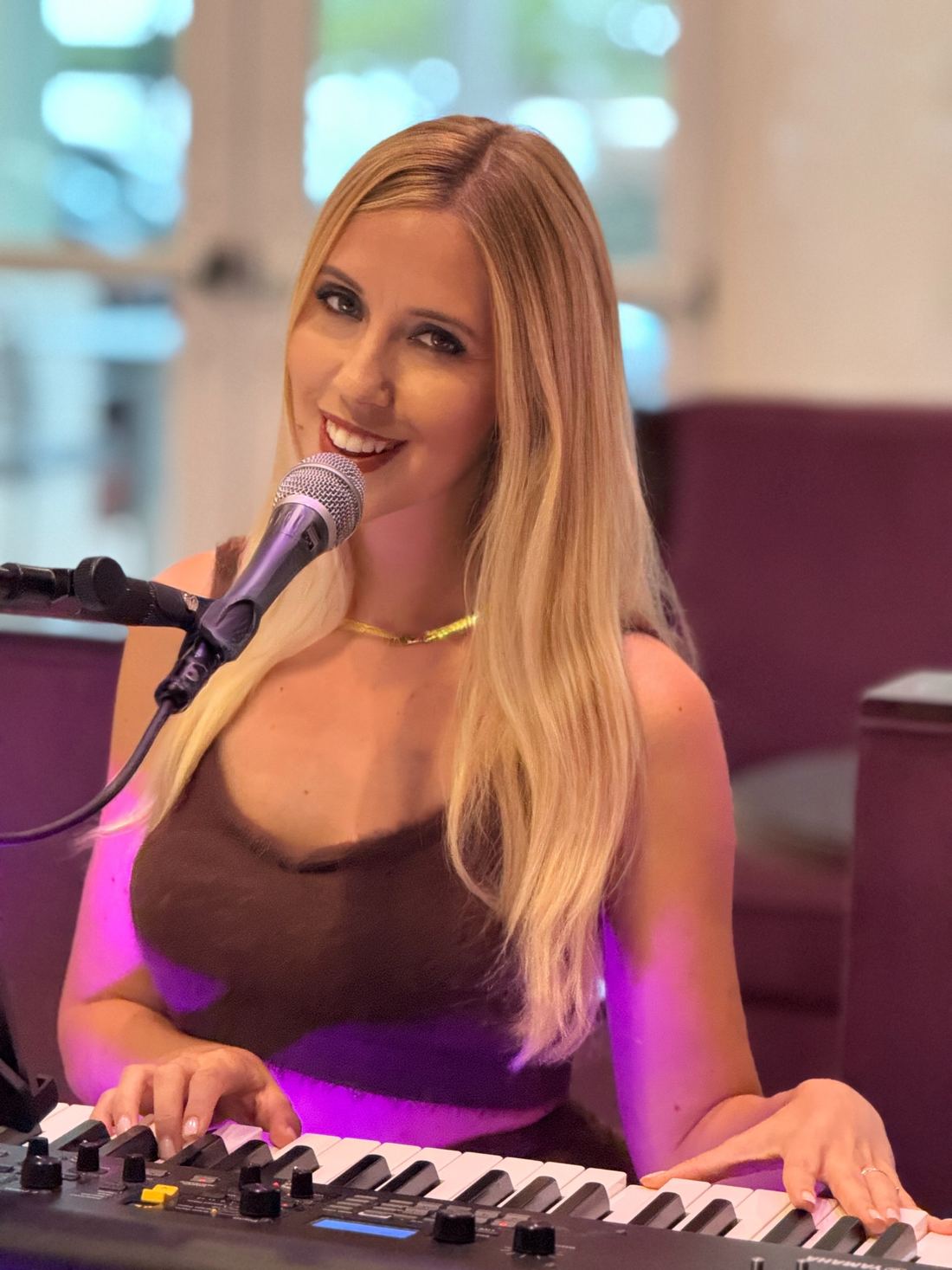 Joanna Holstein smiling at the keyboard during a live show