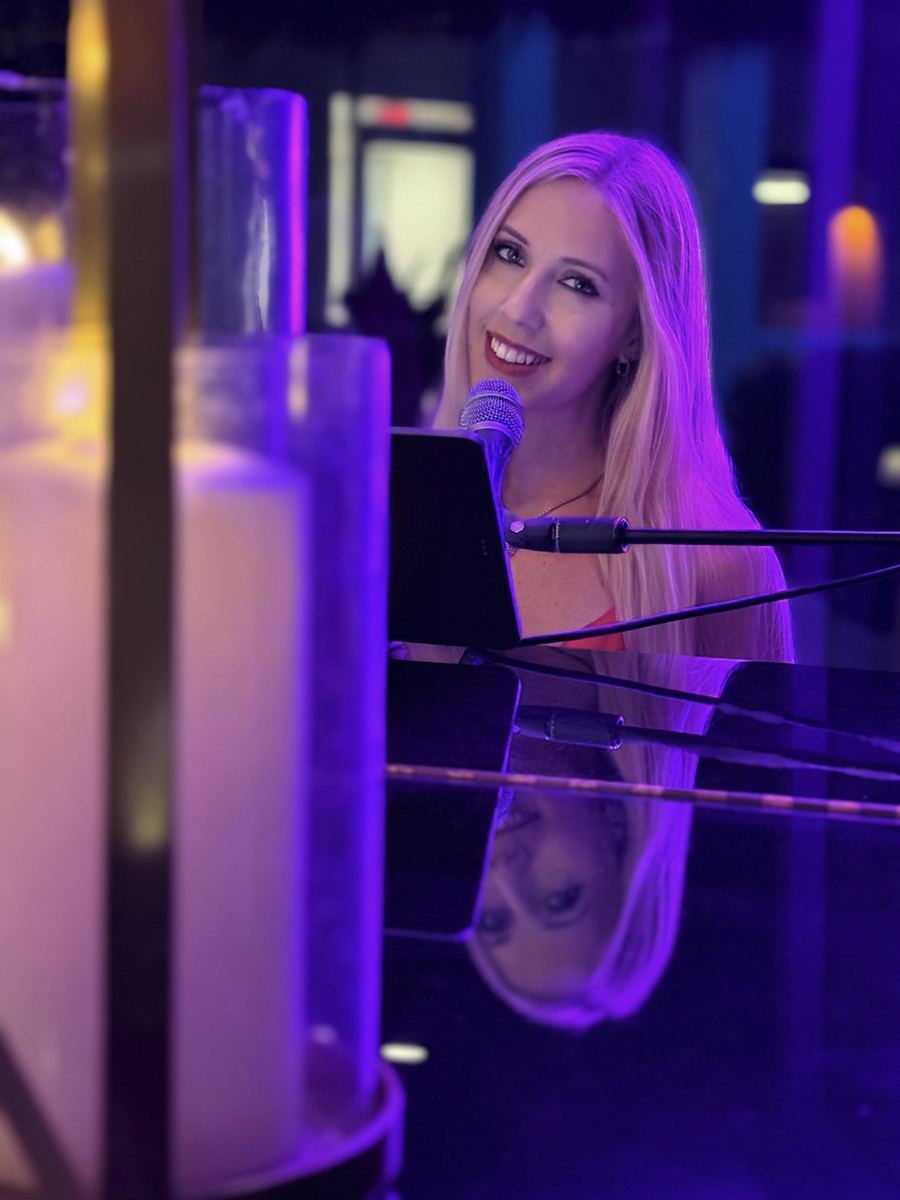 Joanna at the piano under violet light