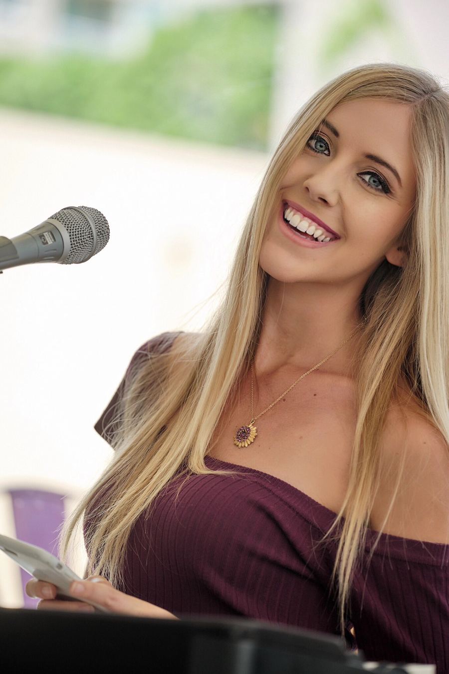 Joanna smiling at the microphone